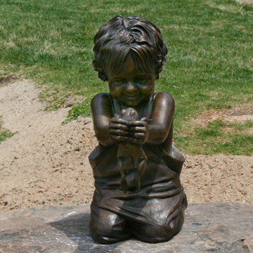 Lifesize portrait bronze memorial sculpture, statue of little boy with a frog, "My Little Buddy", The Childrens Park, Tyler, Texas, Tom White, figurative monumental bronze sculptor, bronze statues of children playing, sculptures of children in parks, family portrait bronze memorials, public bronze sculpture monuments, life-size figurative portrait bronze memorials, sculptures of children playing, bronze portrait statues of children, little boy and frog bronze sculpture, commission a sculpture of a child