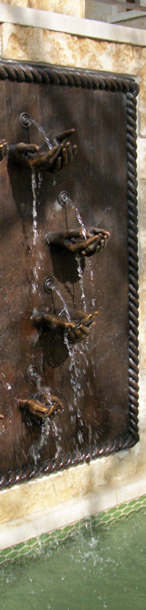 Bronze hands fountain created by bronze portrait artist, Tom White, monumental bronze sculptor, for Dillard family Fort Worth, Texas.  Family heirloom sculpture of hands of father, mother and six kids, custom bronze water fountain featured at home.  Tom specializes in custom commissioned bronze figurative sculptures for memorials, public monuments, family portraits and commemorative bronze