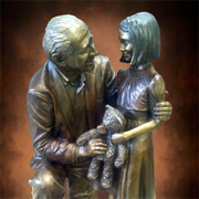 Give Kids The World Custom life-size portrait bronze sculpture of Henri Landwirth, Founder of Give Kids the World Village, Kissimmee, Florida and a child bronze statue, by public monumental bronze sculptor, Tom White, figurative commission bronze statues of public figures, historical events, sculptures of children, war memorials, historical sculpture scenes and faith-based religious statues