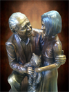 Custom life-size portrait bronze sculpture of Henri Landwirth, Founder of Give Kids the World Village, Kissimmee, Florida and a child bronze statue, by public monumental bronze sculptor, Tom White, figurative commission bronze statues of public figures, historical events, sculptures of children, war memorials, historical sculpture scenes and faith-based religious statues