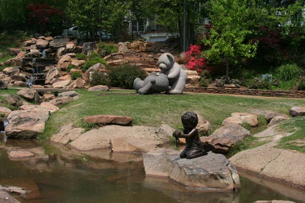 Lifesize portrait bronze memorial sculpture of little boy with a frog placed in the Children's Park Tyler, Texas, family and public monumental sculptures scenes by Tom White, monumental bronze sculptor, figurative portrait bronze memorials, sculptures of children playing, bronze portrait statues of children