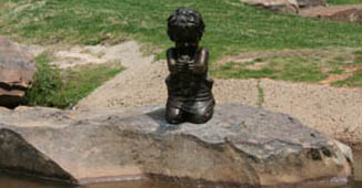 Lifesize portrait bronze memorial sculpture of little boy with a frog placed in the Children's Park Tyler, Texas, family and public monumental sculptures scenes by Tom White, monumental bronze sculptor, figurative portrait bronze memorials, sculptures of children playing, bronze portrait statues of children