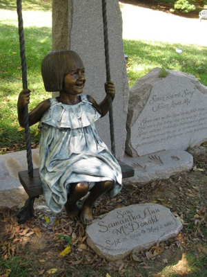 Monumental bronze memorial sculpture of Sami McDonald with statue of Jesus swinging her, Cavehill Cemetery commemorative portrait bronze by Christian Sculptor Tom White.  Children and Jesus sculptures in lifesize and monumental bronze, sculptures of Christ